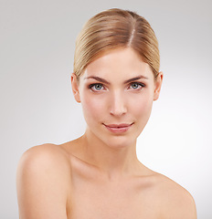 Image showing Beauty, skincare and portrait of woman with facial glow, confidence and cosmetics in studio. Dermatology, healthy skin and serious face of girl on white background with luxury, care and wellness.