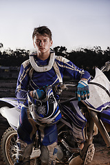 Image showing Sport, portrait and man with off road motorcycle, confidence and gear for competition, race or challenge. Adventure, adrenaline and serious face of athlete on extreme course with dirt bike in evening