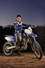 Image showing Extreme sport, portrait and man with off road motorbike, confidence and gear for competition, race or challenge. Adventure, adrenaline and serious face of athlete on course with dirt bike at night