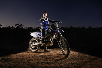 Image showing Extreme sport, portrait and man with dirt bike, confidence and gear for competition, race or challenge. Adventure, adrenaline and serious face of athlete on course with off road motorbike at night