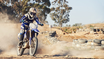 Image showing Motorcycle, person and speed with dust cloud for games, contest or challenge in action for extreme sports. Racer, motorbike and dirt on path, road and trail in nature with fast transport in summer