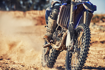 Image showing Closeup, dirt track and wheels of motorcyclist with motorbike for race, extreme sports or outdoor competition. Legs of expert rider on bike, scrambler or sand course for off road rally challenge