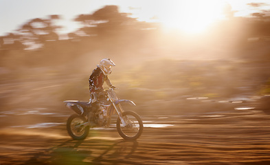 Image showing Motion blur, race and man on off road motorbike with adventure, adrenaline and speed in competition, Extreme sport, sunset and athlete on dirt bike for challenge, power or danger on action course