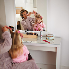 Image showing Mom, daughter and playing with hair in mirror for beauty, care and helping or getting ready. Happy mother, family and girl or kid with rollers for hairstyle, fashion and bonding together at home