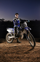 Image showing Sport, portrait and man with dirt bike, extreme confidence and gear for competition, race or challenge. Adventure, adrenaline and serious face of athlete on course with off road motorcycle in evening