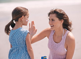 Image showing Woman, child and sunscreen protection on beach or summer holiday on tropical island, application or bonding. Female person, daughter and lotion at California seaside or care, healthy skin or safety