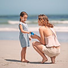 Image showing Mother, child and sunscreen with skincare health on beach for summer holiday, tropical island or bonding. Female person, daughter and lotion application at California seaside, protection or safety