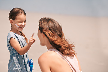 Image showing Mother, daughter and nose with sunscreen on beach for summer protection for healthy skin, safety or weekend. Woman, child and happy in Florida for bonding holiday for vacation, sunshine or outdoor