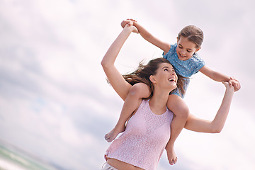 Image showing Happy mother, beach and child on piggyback for fun summer, playful holiday or outdoor weekend in nature. Mom and daughter or kid on shoulders with smile for bonding, love or support by ocean coast