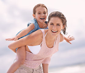 Image showing Mother, child and piggyback, flying on beach for bonding and love, travel and vacation in Mexico. Happy, care and trust, woman and daughter playing game with airplane and family outdoor in portrait