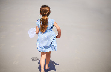 Image showing Child, outdoor and running with fishing net or nature explore in summer or vacation adventure, travel or rear view. Female person, kid and sand in Florida for holiday destination, health or mockup