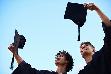 Image showing Graduation, university and students with hats in sky for learning, studying and knowledge on academy campus. Education, friends and happy men throw for celebration, graduate ceremony and college