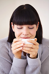 Image showing Tea cup, espresso and woman in home to drink with smile from happiness of beverage. Female person, peace and morning for girl in apartment to relax, hot chocolate and cozy in house on coffee break