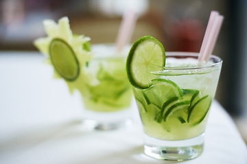 Image showing Cocktail, alcohol and glass with fruit for mojito drink on table for party, club and bar. Mockup, background and closeup of mocktail, beverage and liquid with lime, ice and liquor for celebration