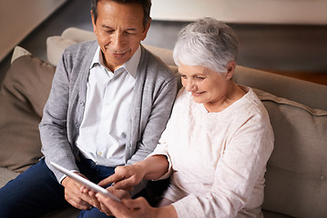 Image showing Senior, couple and happiness with tablet on sofa for online bingo, crossword puzzle or internet games in living room. Elderly, man and woman with face or top view with technology for web news in home