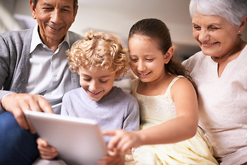 Image showing Happy family, grandparents and kids with tablet for entertainment or social media on sofa at home. Grandma, grandpa and children with smile, hug and love on technology for bonding or game at house