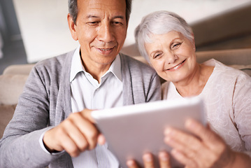 Image showing Senior, couple and smile with tablet on sofa for online bingo, crossword puzzle and internet games in living room. Elderly, man and woman with face and happiness with technology for web news in home