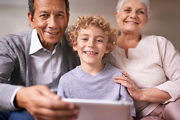 Image showing Happy family, portrait and grandparents with child on tablet for entertainment, social media or research on sofa at home. Grandma, grandpa and kid smile with technology for online connection at house