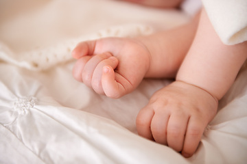 Image showing Baby, hands and fingers on bed as closeup for childhood development or nursery sleeping, relax or resting. Kid, wellness and childcare in home for wellbeing nap or dreaming nurture, caring or calm