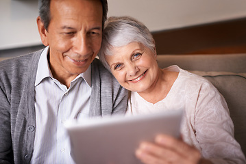 Image showing Senior, couple and portrait with tablet on sofa for online bingo, crossword puzzle and internet games with smile. Elderly, man and woman with face and happiness with technology for web news in home