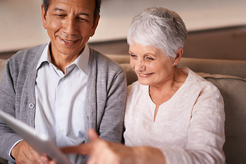 Image showing Senior, couple and happiness with tablet on couch for online bingo, crossword puzzle and internet games in living room. Elderly, man and woman with face or smile with technology for web news in home