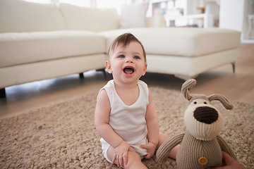 Image showing Baby, teddy bear and toy on living room floor or morning playing in home for resting development, childhood or happiness. Kid, boy and lounge in apartment by couch for weekend joy, fun or relaxing