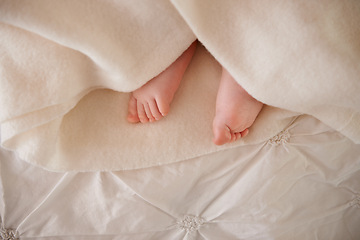 Image showing Baby, feet and toes or blanket on bed for childhood development or nursery sleeping, relax or resting. Kid, wellness and childcare as closeup for wellbeing nap or dreaming nurture, caring or calm