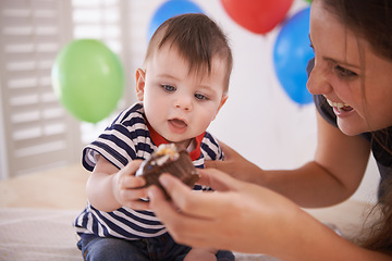 Image showing Baby, mother and birthday party with cake or balloons in home for celebration of special day, decoration or development. Child, parent and sweet dessert with accessories or event, surprise or happy