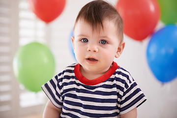 Image showing Baby, portrait and balloons or birthday party celebration on special day or decoration, inflatable or development. Childhood, boy and face at home or milestone event or growth youth, relax or weekend