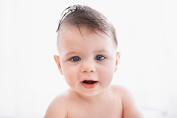 Image showing Cute, portrait and baby in bathtub at house for infant hygiene, health and wellness routine. Sweet, happy and adorable young boy toddler, child or kid washing body for clean skin in bathroom at home.