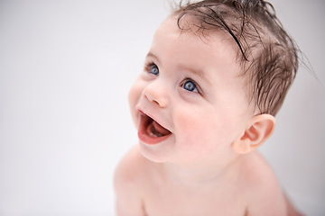 Image showing Sweet, cute and baby in bathtub at house for infant hygiene, health and wellness routine. Happy, smile and adorable young boy toddler, child or kid washing body for clean skin in bathroom at home.