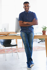 Image showing Arms crossed, smile and portrait of man by desk in office for vision, web design or startup company. Happy, confident and creative person by table with technology for entrepreneur, research or pride