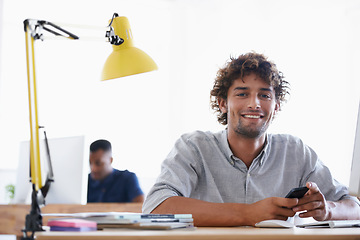 Image showing Creative, coworking space and portrait of man with phone at desk for networking on project in happy office. Relax, smile or professional designer with smartphone, research and architecture business.