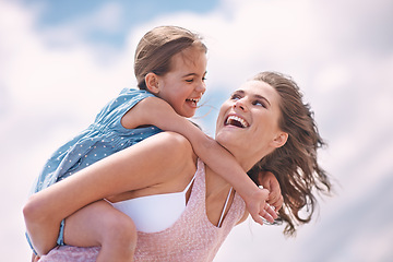 Image showing Mother, daughter and piggyback or happy on the beach for bonding and love, travel and vacation in Mexico. Freedom, care and trust, woman and girl kid play game with joy and family together outdoor