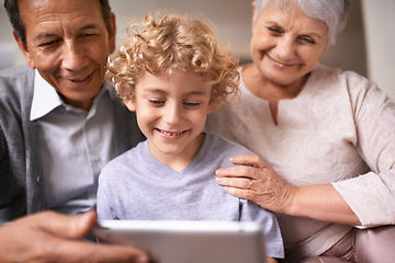 Image showing Happy family, grandparents and child with tablet for entertainment, social media or research on sofa at home. Grandma, grandpa and little boy smile on technology for online search or movie at house