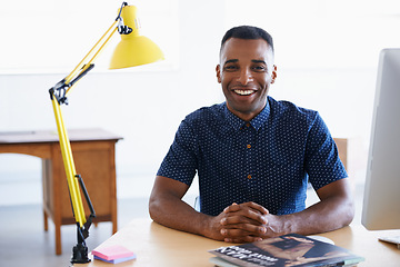 Image showing Young businessman, portrait and happy in office by desk, consultant and creative in career. Smile, black man or positive face of journalist in co working space or professional for ambition in company