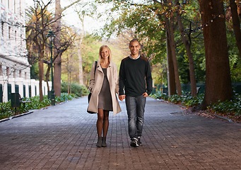 Image showing Happy, holding hands and portrait of couple in park for bonding, relationship and love outdoors. Interracial, dating and man with woman walking for fashion, care and weekend to relax together