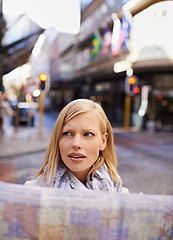 Image showing Travel, map and confused with woman in city to search for directions to tourist location abroad. Thinking, stress and doubt with young person lost in overseas urban town for holiday or vacation