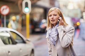 Image showing Business woman, phone call and city for travel, commute to work with public transport. Real estate agent, cellphone and talking on smartphone, technology and professional while walking downtown