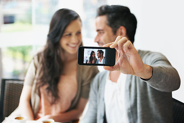 Image showing Happy couple, selfie or love in coffee shop on vacation or post on social media of romantic date together. Man, woman or care in marriage in profile picture or connection on cellphone in restaurant