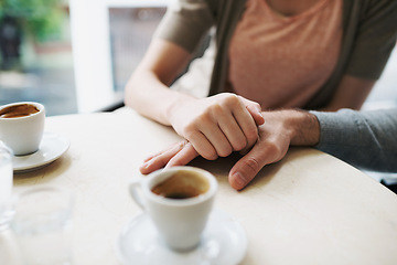Image showing Couple, holding hands and love in coffee shop on vacation and bonding together by espresso date. Man, woman and care in restaurant with morning cappuccino, touch and romantic or support in marriage