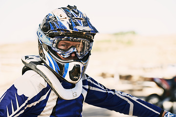 Image showing Motorbike, extreme sport and portrait for man in helmet for competition, race and games with safety. Person, motorcycle and outdoor for contest, motor cross and fast transport with speed in desert