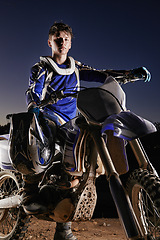 Image showing Sport, competition and portrait of man with off road motorbike, confidence and gear for race challenge. Adventure, adrenaline and serious face of athlete on extreme course with dirt bike in evening