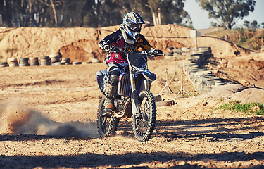 Image showing Motorbike, person and speed with dust cloud for games, contest or challenge in action for extreme sports. Racer, motorcycle and dirt on path, road and trail in nature with fast transport in summer
