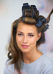 Image showing Woman, face and smile with hair curlers for beauty, haircare and hairstyle with makeup or cosmetics at hairdresser. Person, happy and roller set for grooming, curling and getting ready with skincare