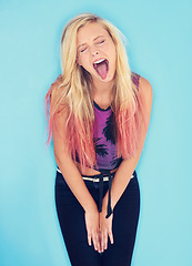Image showing Crazy, studio and gen z fashion for unique girl on blue background, comic and outfit for youth. Punk, fun and female person with long dyed hair, funny face and cool as model for summer clothes