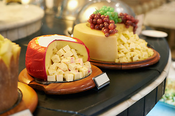 Image showing Food, cheese and fruit in restaurant display for catering service, buffet selection and banquet for eating. Cafeteria, fine dining and closeup of table for lunch, supper and dinner event for wellness