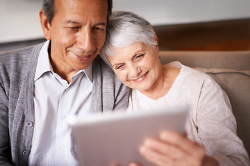 Image showing Senior, couple and hug with tablet on sofa for online bingo, crossword puzzle or internet games with smile. Elderly, man and woman with face, happiness or embrace with technology for web news in home