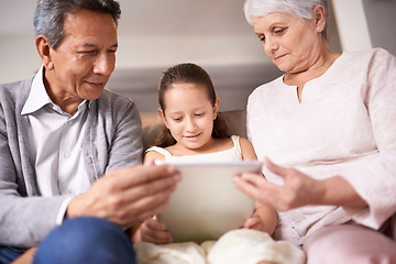 Image showing Family, grandparents and girl with tablet for entertainment, social media or research on sofa at home. Grandma, grandpa and child with smile on technology for online search, show or movie at house