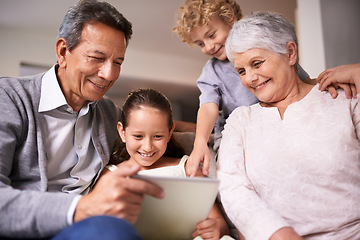 Image showing Happy family, grandparents and kids with tablet for social media, entertainment or research on sofa at home. Grandma, grandpa and young children smile on technology for online show or movie at house